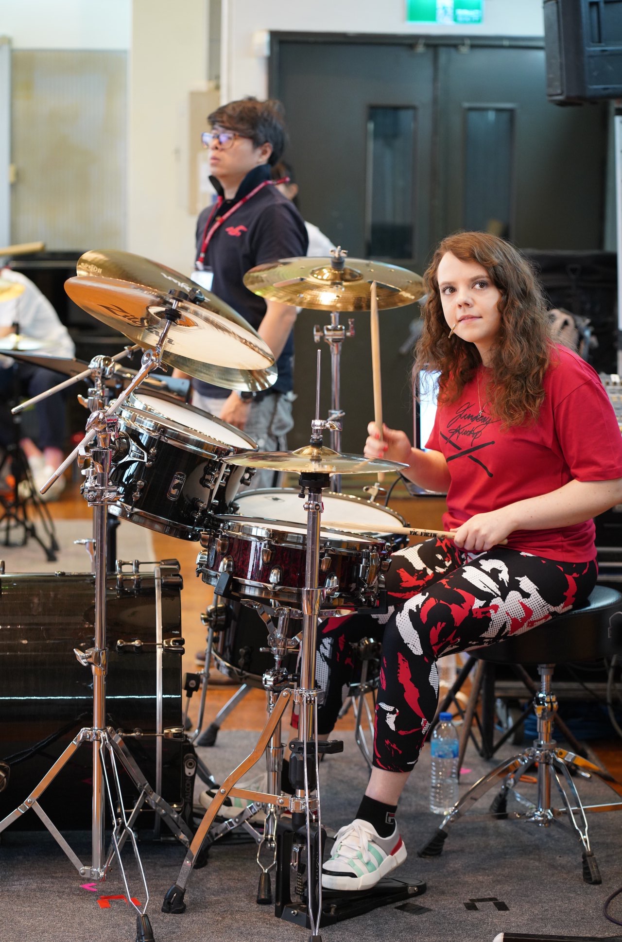 Female drummer Lindsay Artkop playing drums with her drum students during a successful session