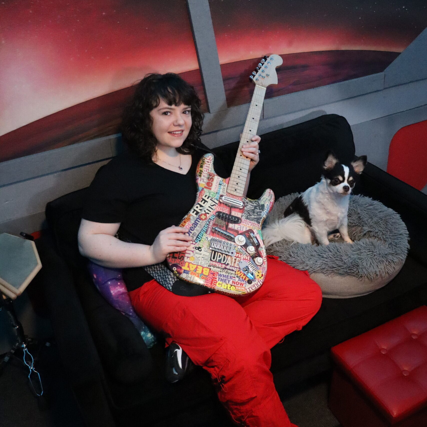 Lindsay Artkop on her couch in her spaceship ufo music studio in los angeles, california with her dog oswald