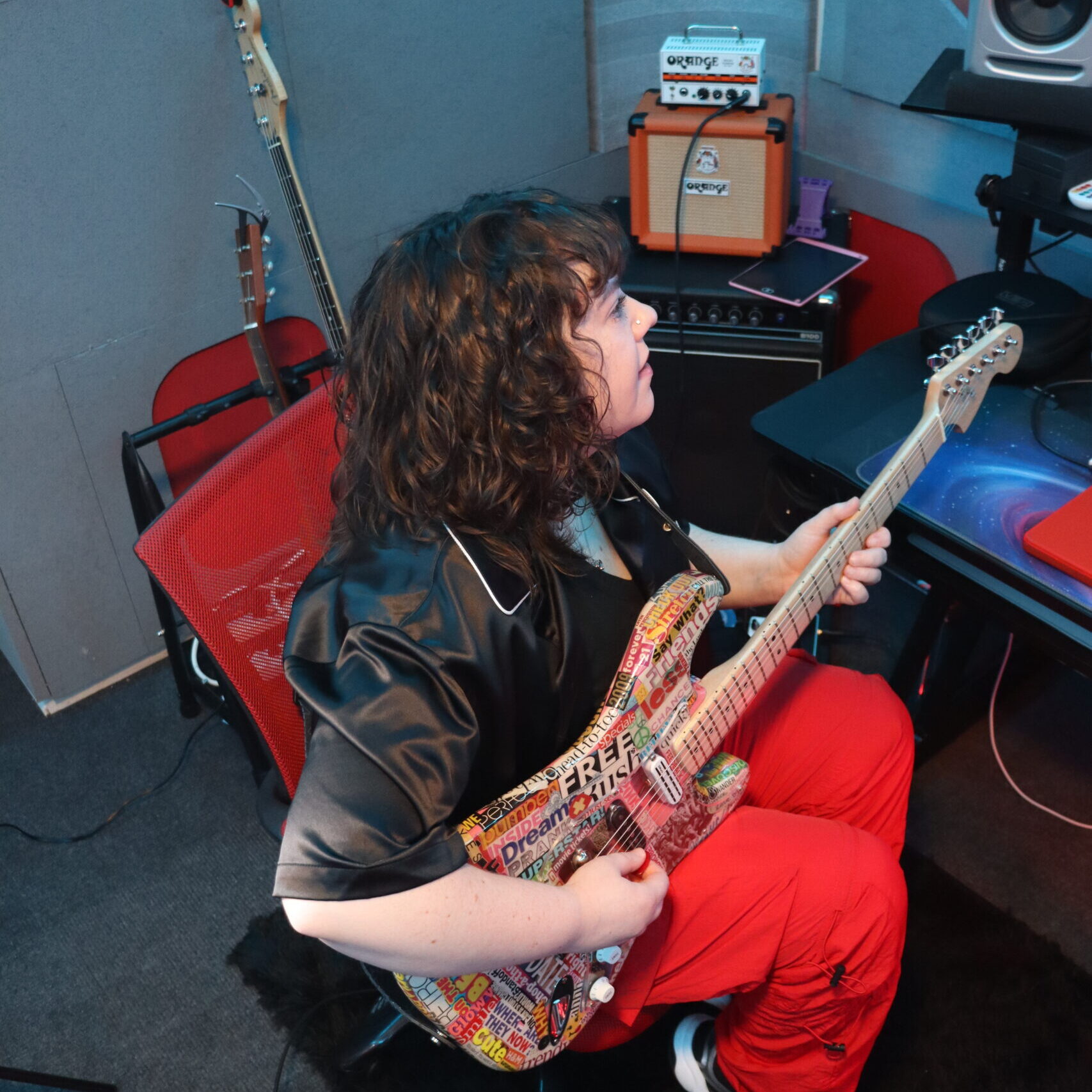 Lindsay Artkop plays guitar in music studio